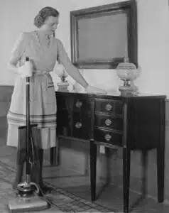 Woman dusting and using a vacuum